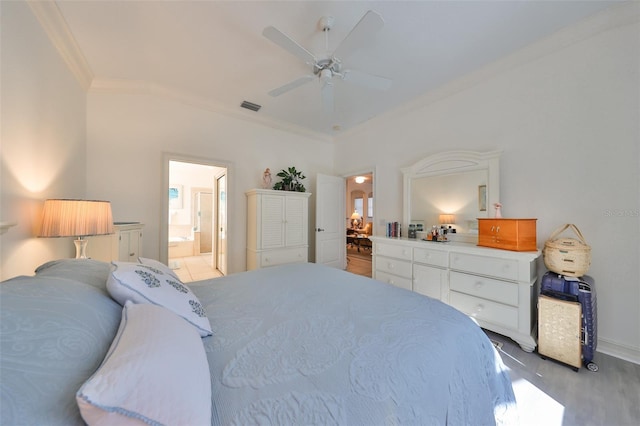 bedroom featuring ceiling fan, ornamental molding, ensuite bathroom, and light hardwood / wood-style flooring