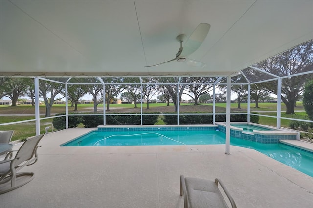 view of swimming pool featuring an in ground hot tub, glass enclosure, ceiling fan, and a patio area