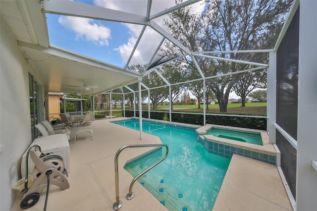 view of pool featuring a lanai, a patio area, and an in ground hot tub