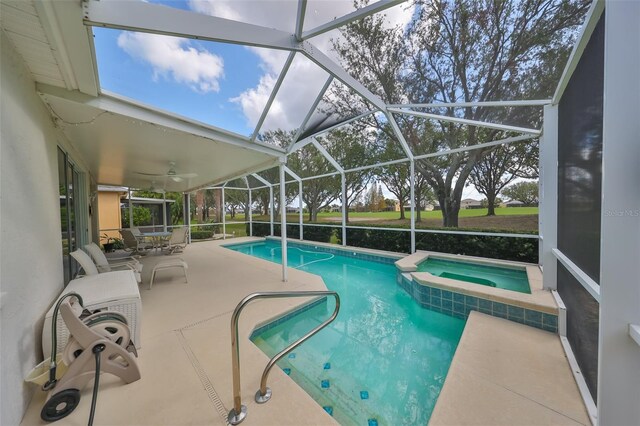 1120 Emerald Dunes Dr, Sun City Center, FL 33573 - view of pool featuring a patio, a pool with connected hot tub, ceiling fan, and glass enclosure