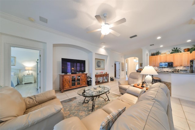 tiled living room with ceiling fan and ornamental molding