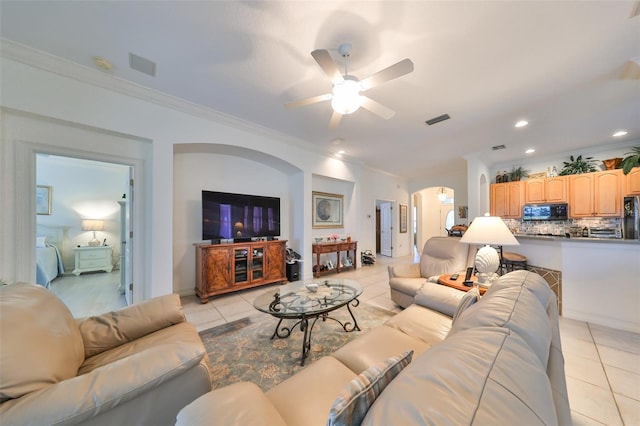 1120 Emerald Dunes Dr, Sun City Center, FL 33573 - living room featuring arched walkways, light tile patterned floors, crown molding, ceiling fan, and recessed lighting