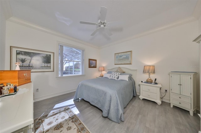 bedroom with light hardwood / wood-style flooring, ceiling fan, and ornamental molding