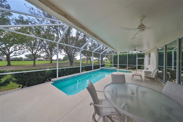 view of swimming pool featuring a patio, ceiling fan, and a lanai