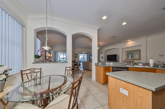 kitchen featuring light tile patterned floors, ornamental molding, sink, and dishwasher