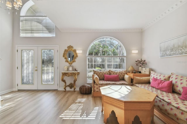 living room with french doors, an inviting chandelier, wood finished floors, and baseboards