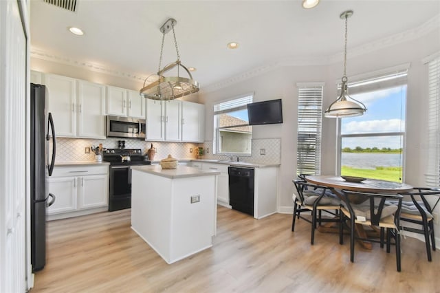 kitchen featuring black appliances, pendant lighting, light hardwood / wood-style flooring, white cabinets, and a kitchen island