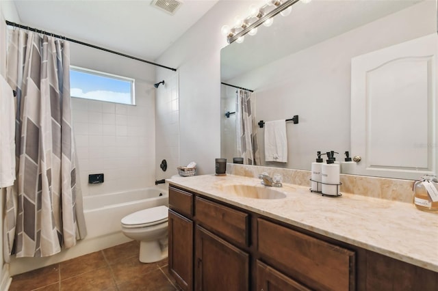 full bathroom with toilet, tile patterned floors, vanity, and shower / tub combo with curtain