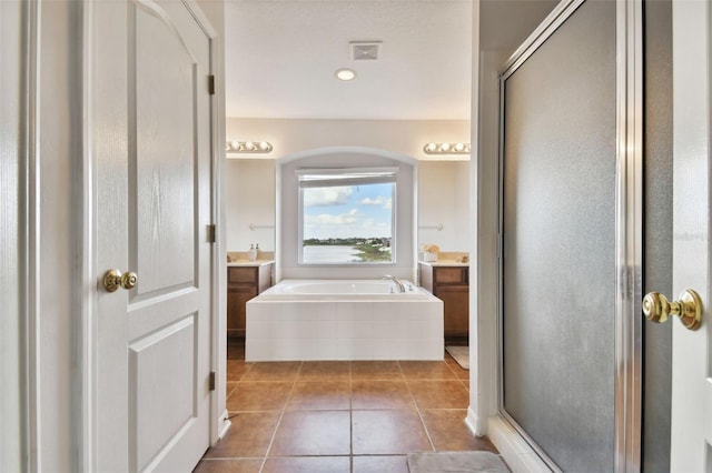 bathroom featuring tile patterned flooring, vanity, and separate shower and tub