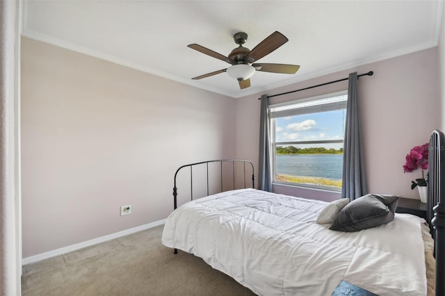 carpeted bedroom featuring a water view, ceiling fan, and crown molding