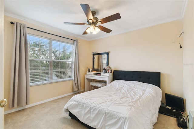 bedroom featuring light colored carpet, ceiling fan, and crown molding