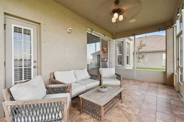 sunroom with a ceiling fan and a wealth of natural light