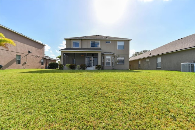 view of front of house with a front lawn, cooling unit, a sunroom, and stucco siding