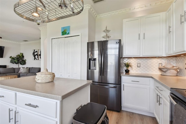 kitchen featuring ornamental molding, white cabinetry, stainless steel refrigerator with ice dispenser, and tasteful backsplash