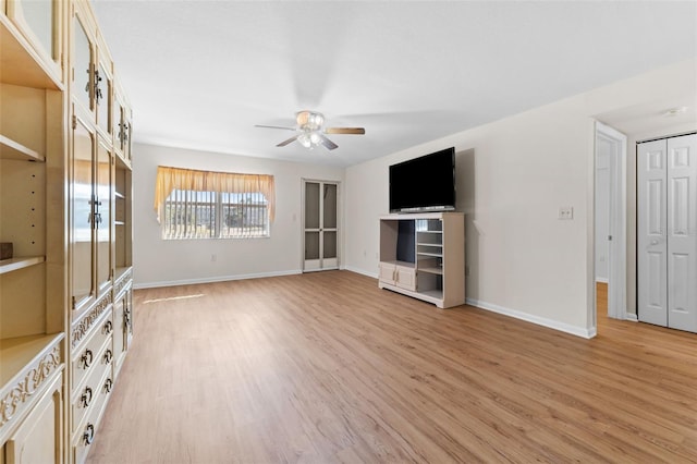 unfurnished living room featuring ceiling fan and light hardwood / wood-style floors