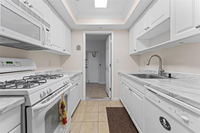 kitchen featuring ornamental molding, white appliances, a tray ceiling, sink, and white cabinetry