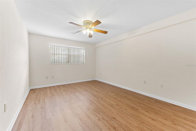 spare room featuring light hardwood / wood-style floors and ceiling fan