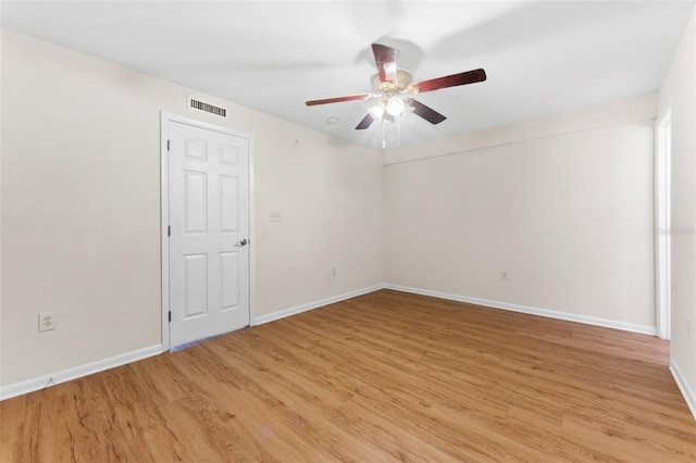 spare room featuring ceiling fan and light hardwood / wood-style floors