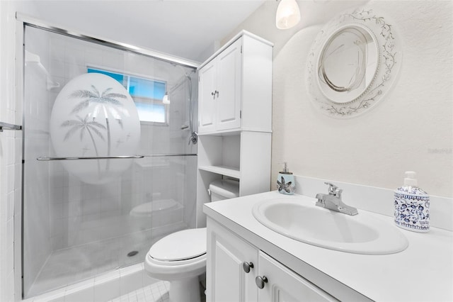 bathroom featuring vanity, a shower with door, tile patterned flooring, and toilet