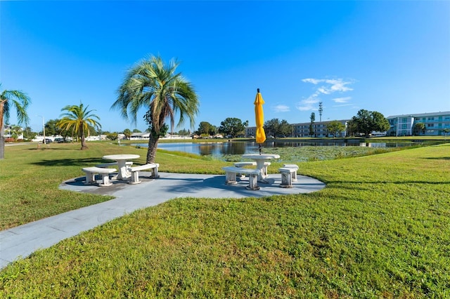 view of home's community with a lawn and a water view