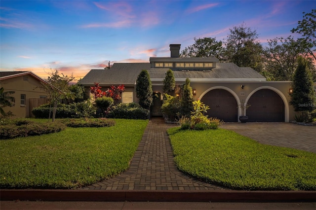 view of front facade featuring a garage and a lawn