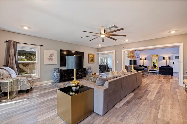 living room with light wood-type flooring and ceiling fan