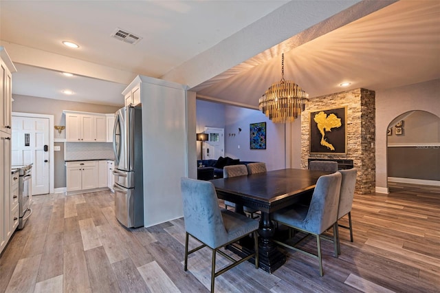 dining room featuring an inviting chandelier and light hardwood / wood-style flooring