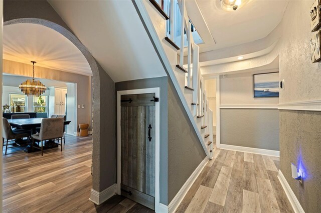 interior space with a chandelier and light hardwood / wood-style flooring