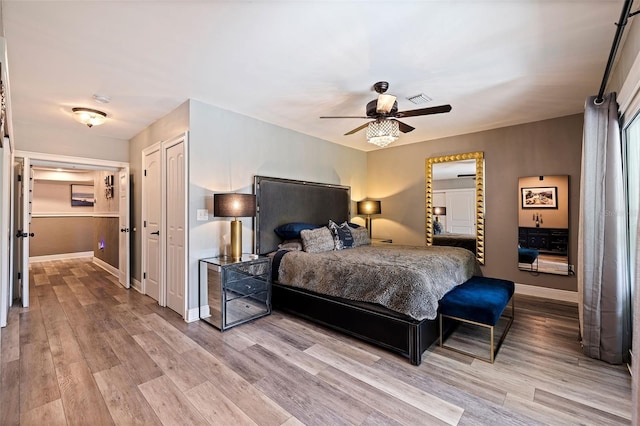 bedroom featuring a closet, light hardwood / wood-style floors, and ceiling fan