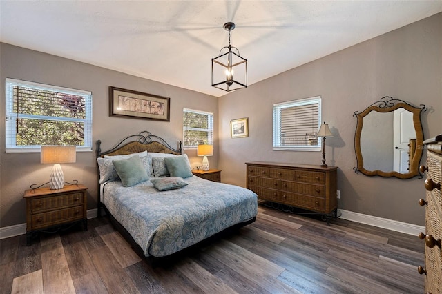 bedroom featuring dark hardwood / wood-style flooring and vaulted ceiling