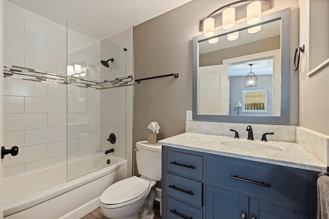 full bathroom with vanity, toilet, and tiled shower / bath combo