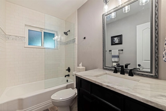 full bathroom featuring vanity, toilet, and tiled shower / bath combo