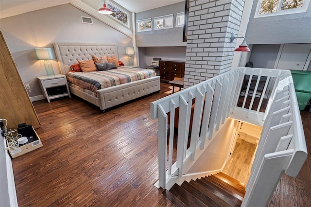 bedroom featuring dark wood-type flooring and a high ceiling