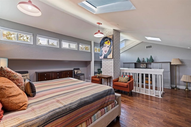 bedroom with dark hardwood / wood-style floors and lofted ceiling with skylight