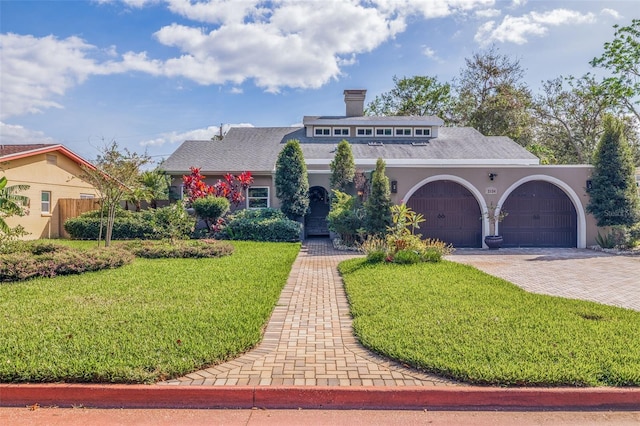 view of front of home featuring a garage and a front yard