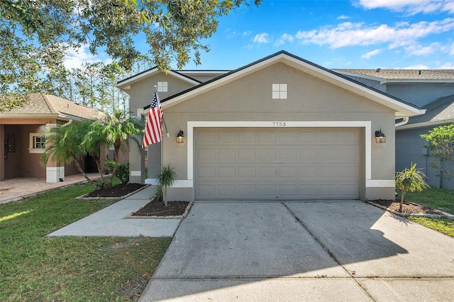 view of front of property with a garage and a front lawn