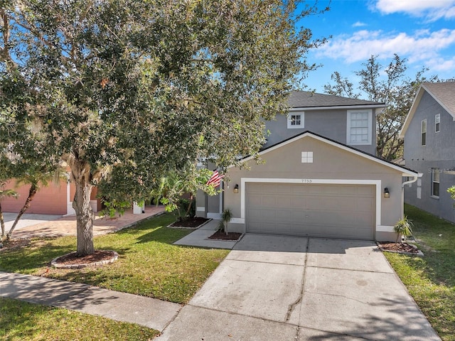 view of front of property featuring a garage and a front lawn