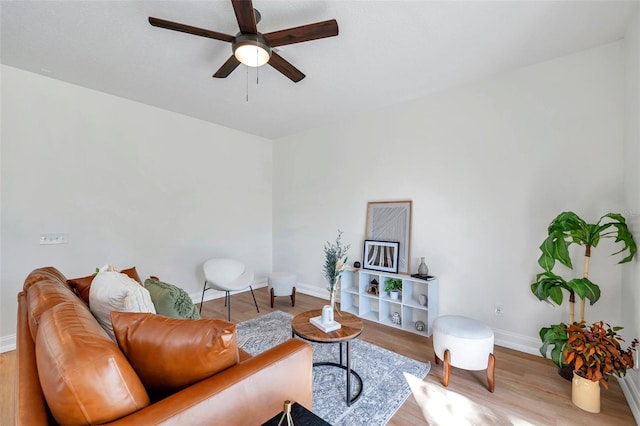 living room featuring ceiling fan and light wood-type flooring