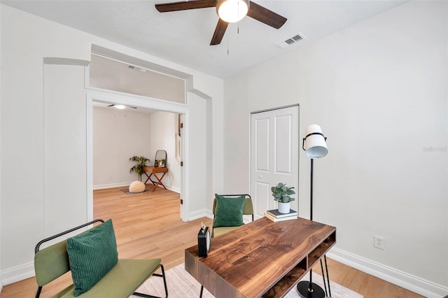 office featuring wood-type flooring and ceiling fan