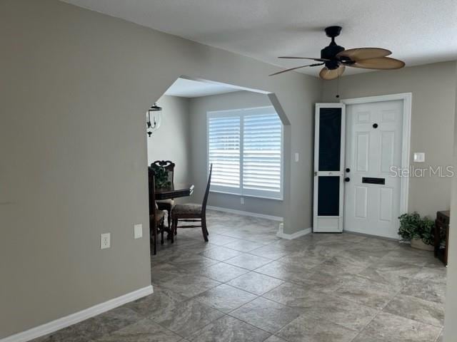 entrance foyer with ceiling fan