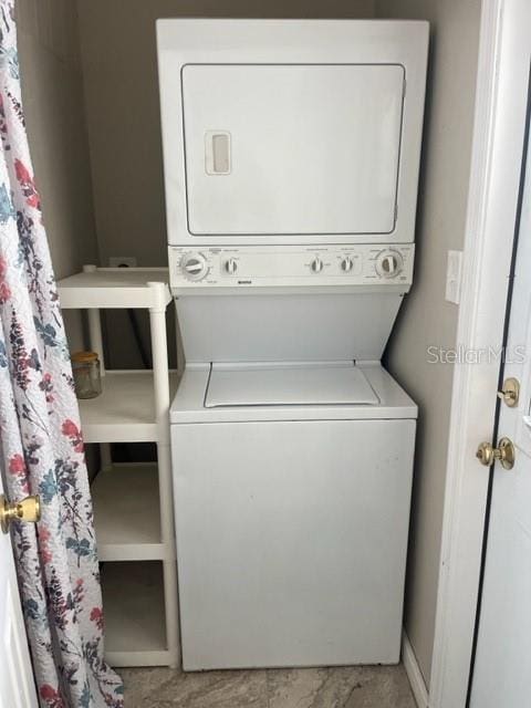 laundry area with stacked washer / drying machine