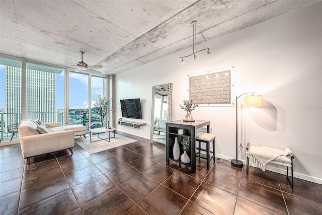 tiled living room with ceiling fan and a wall of windows