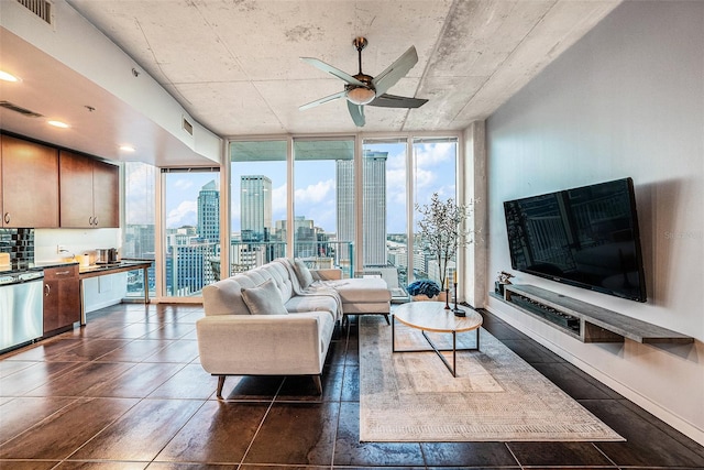 living room with expansive windows, plenty of natural light, and ceiling fan