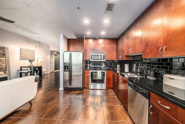 kitchen featuring decorative backsplash, sink, and appliances with stainless steel finishes