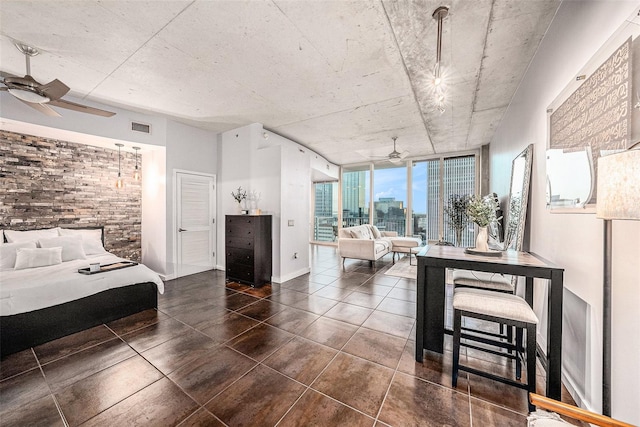 bedroom with ceiling fan and dark tile patterned flooring