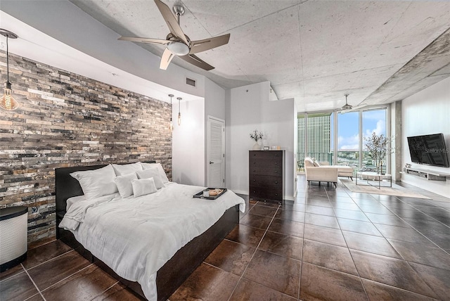 bedroom featuring brick wall, ceiling fan, a wall of windows, and a closet