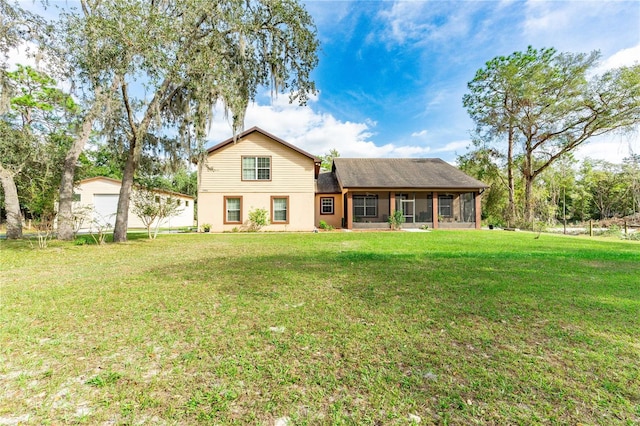 back of house with a lawn and a sunroom