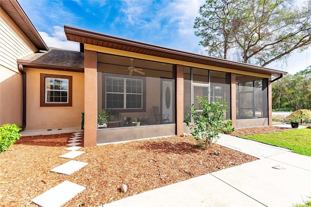 view of front facade with a sunroom and ceiling fan