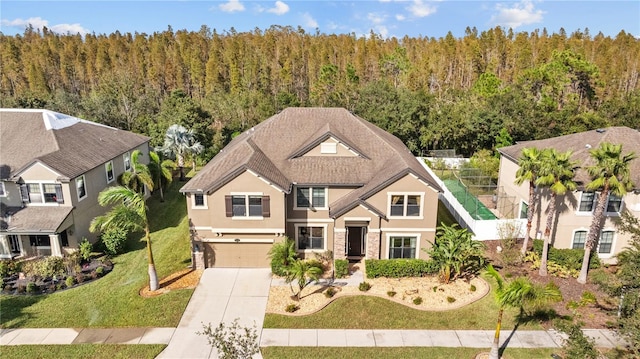 view of front of home featuring a garage and a front yard