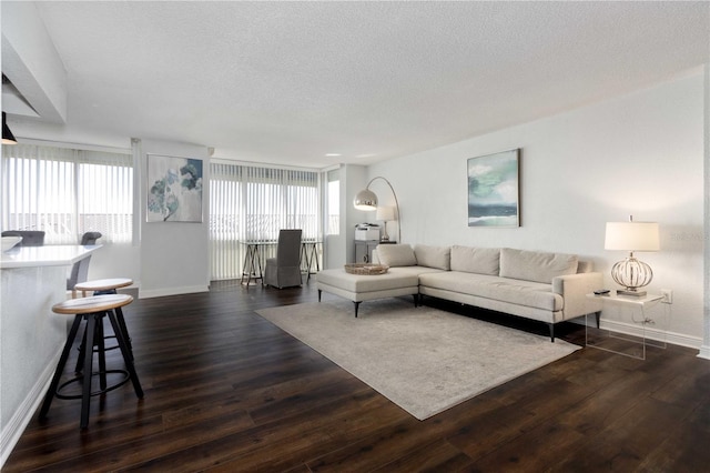 living room featuring dark hardwood / wood-style floors and a textured ceiling